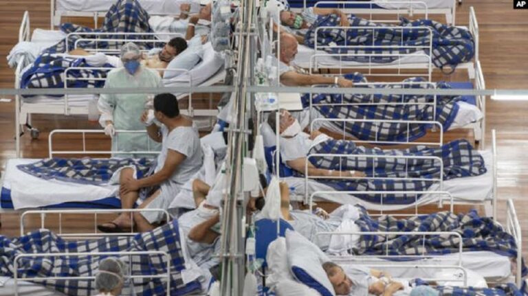 Pasien COVID 19 berbaring di ranjang di rumah sakit lapangan yang dibangun di dalam gym di Santo Andre di pinggiran Sao Paulo Brazil